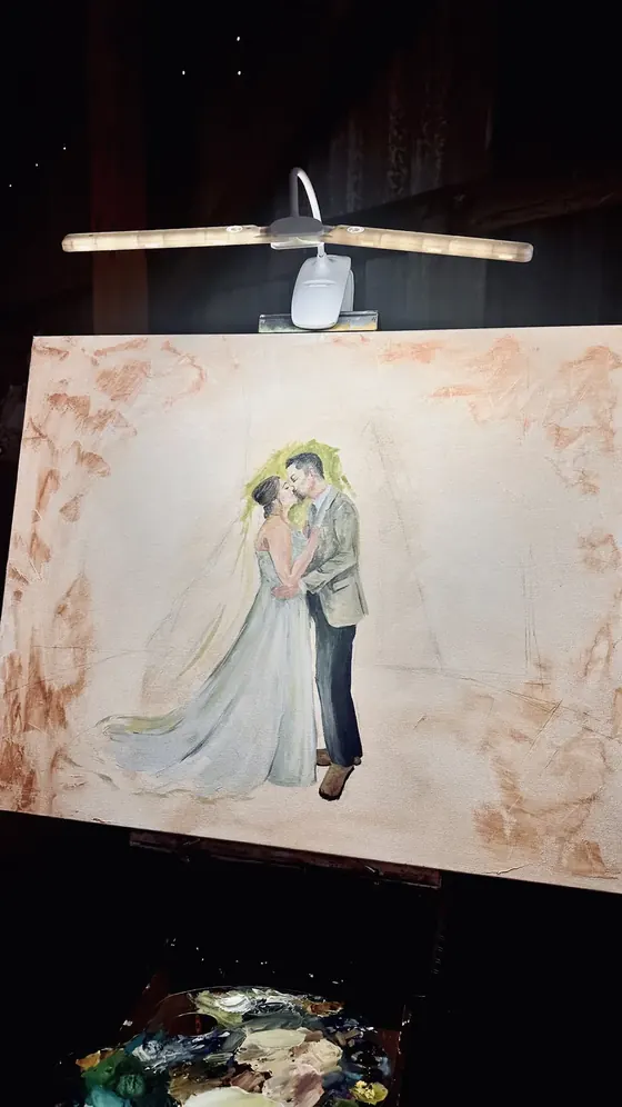 Live wedding painting begins at a barn venue