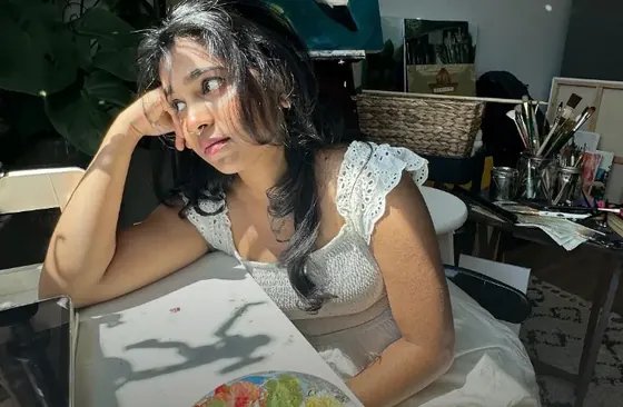 Arthana finishing a wedding painting in her studio